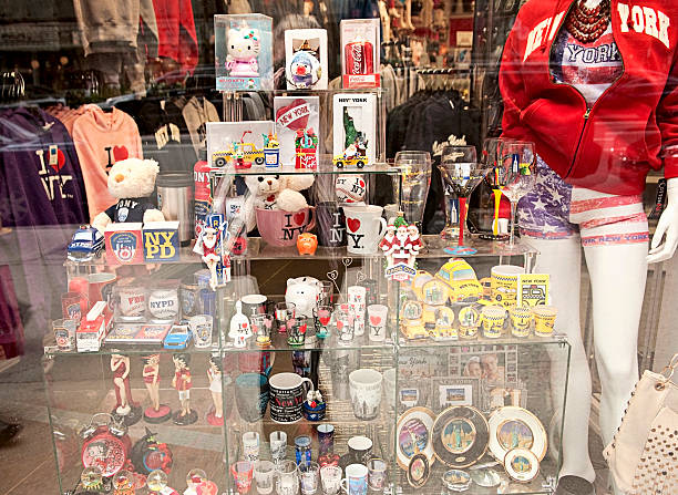 New York Souvenirs and Gifts "New York, New York, USA - November 25, 2012: Souvenirs displayed at the gifts shop in New York City located by Time Square in Midtown Manhattan. Selling yellow taxi toys, shot glasses, mugs, clothes with New York logo." new york state license plate stock pictures, royalty-free photos & images