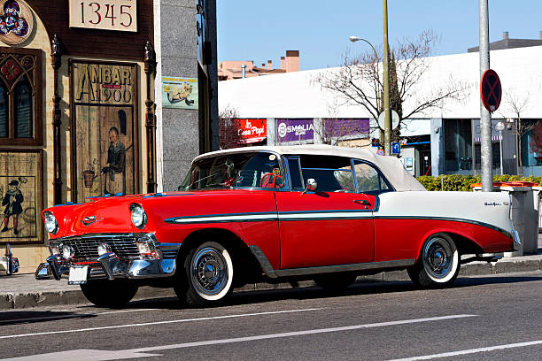 1955 Chevrolet Bel Air "Madrid, Spain - March 24, 2012: 1955 red and white Chevrolet Bel Air convertible in the street , in an exhibition of classic cars in Madrid, Spain. The car has white wallted tires." bel air photos stock pictures, royalty-free photos & images