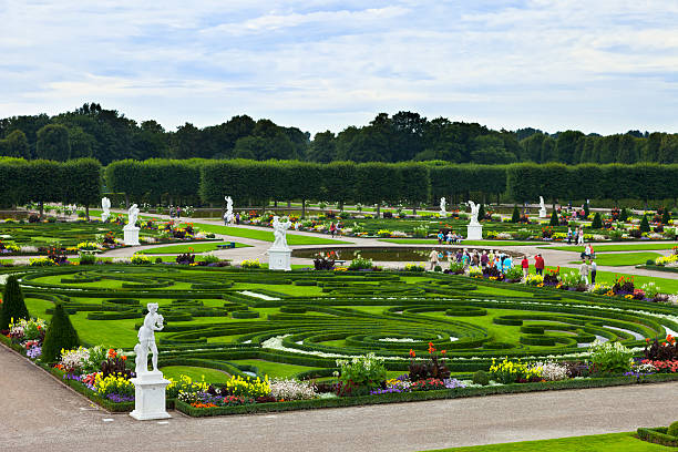 The Great Garden "Hannover, Germany. August 5, 2012: These unique garden grounds, laid out in a baroque style, are one of the most famous attractions in Hannover. Grober Garden was sculpted in 1699 on the request of princess Sophie. Pictured are some of the many tourists visiting the place that day." knot garden stock pictures, royalty-free photos & images