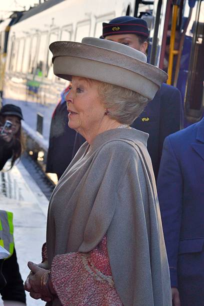 Kampen, The Netherlands - December 6, 2012: Queen Beatrix of the Netherlands arriving at the new train station Kampen Zuid on the day of the opening of the new Hanzelijn railroad. Queen Beatrix has been the Dutch head of state since 30 April 1980 until  present. People in the background are taking pictures and looking at the queen.