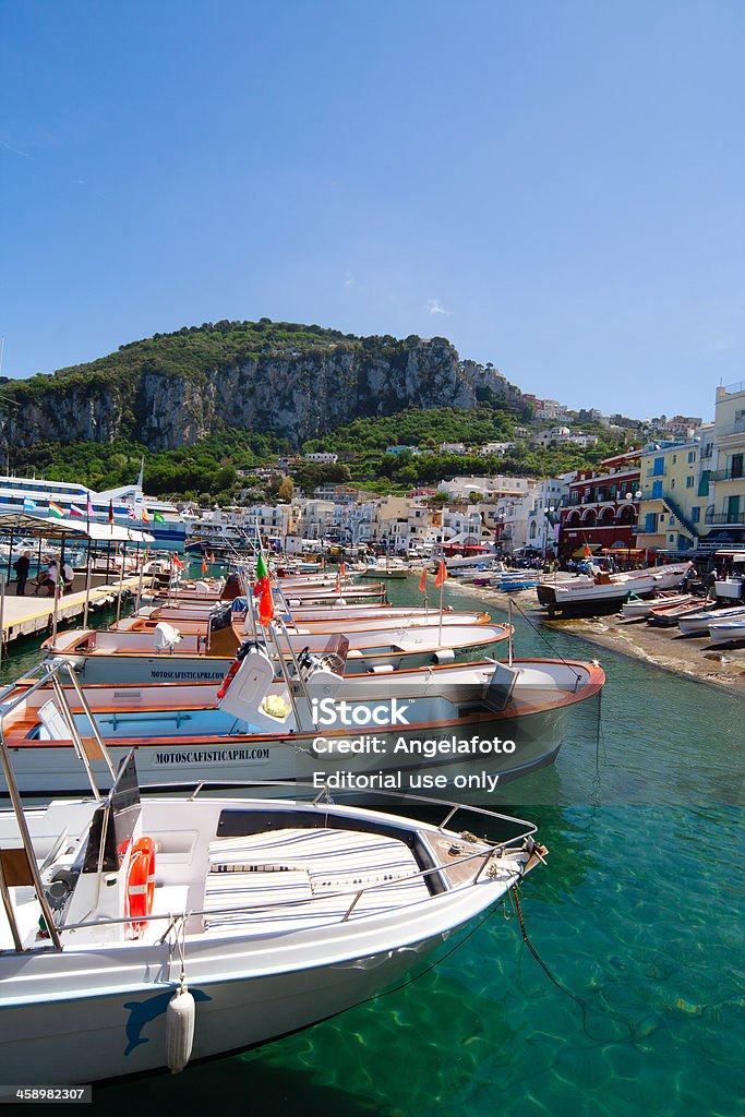 Capri island Landscape from Harbur of Marina Grande, Italy "Capri, Italy - May 8, 2012: Capri island Landscape from Harbur of Marina Grande, photo taken at noon from the beach, many people walking on the street in background, Italy" Amalfi Stock Photo