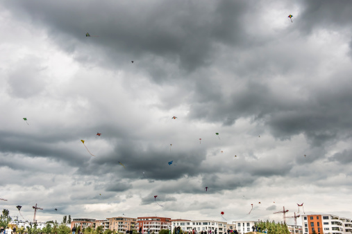 Ostfildern, Germany - October 3, 2012: Many kites the air, kite-festival under dark cloudy sky