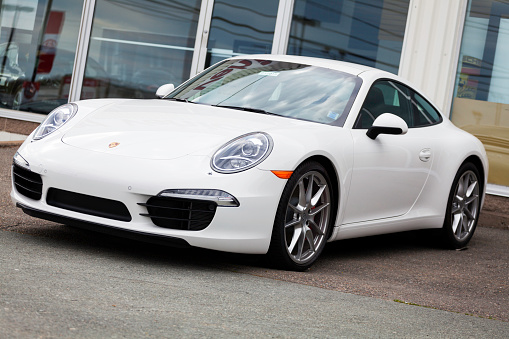 Halifax, Nova Scotia, Canada - May 13, 2012: A Porsche 911 Carrera S 991 Series on display at a Porsche dealership in Halifax, Nova Scotia.  Dealership showroom visible in background with other vehicles inside.  The 991 Carrera S features a 3.8-liter, 400 hp engine and is the first to use mostly aluminum construction.  It is only the third entirely new platform for the 911 since it's introduction in 1963.
