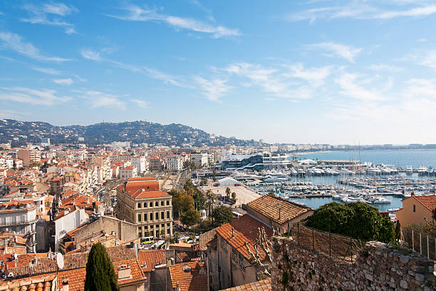 View to Cannes, France "Cannes, France - February 29, 2012: View to the skyline of Cannes and the Mountain Maritime Alps. In foreground are standing the historical buildings. In the background of the picture begins the famous waterside promenade La Croisette with the palace for the Cannes Film Festival and the yacht harbor." cannes film festival stock pictures, royalty-free photos & images