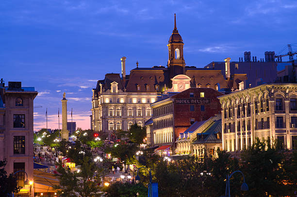 City hall and Place Jacques-Cartier in Montreal, Quebec at night "Montreal, Canada - August 24, 2012: People mill about Place Jacques-Cartier in the Old Montreal section of Montreal with Nelson's Column and City Hall nearby." place jacques cartier stock pictures, royalty-free photos & images