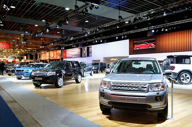 Land Rover stood Brussels, Belgium - January 10, 2012: Land Rover stand with the Freelander and Evoque on display during the 2012 Brussels motor show. People in the background are looking at the cars. evoque stock pictures, royalty-free photos & images