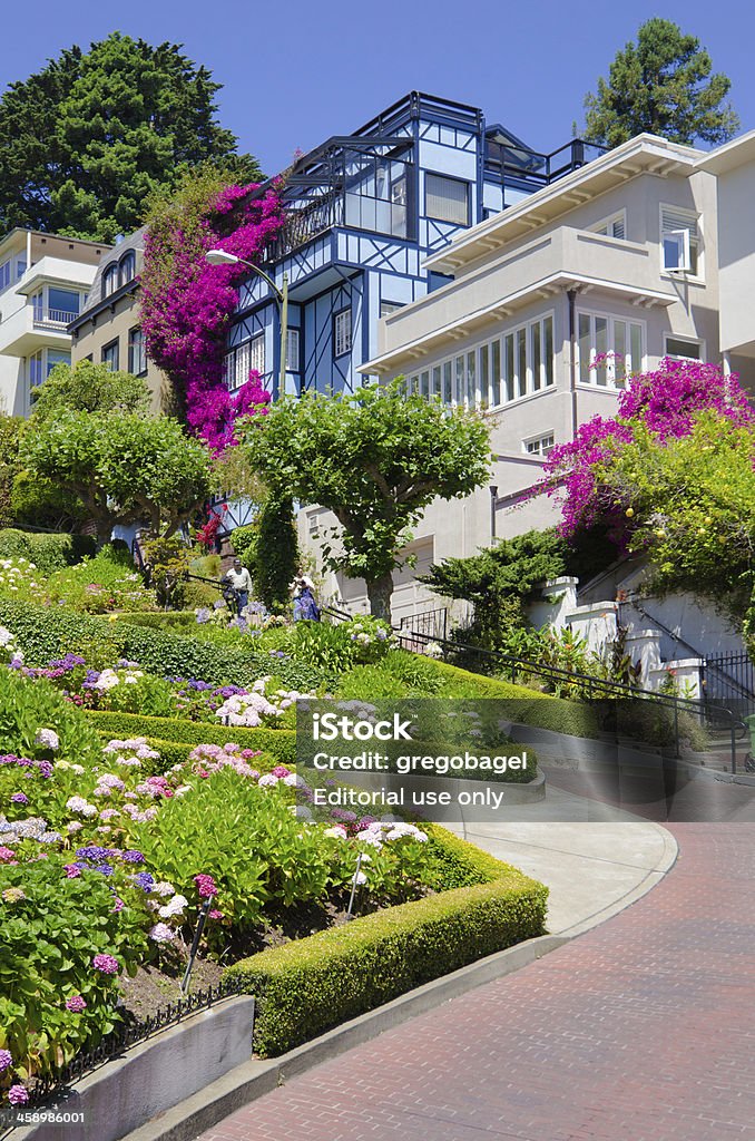 Lombard Street on Russian Hill in San Francisco, CA "San Francisco, United States - July 3, 2012: People mill about Lombard Street in the Russian Hill neighborhood of San Francisco. The east-west street is known for it's one block section from Hyde Street to Leavenworth Street that has eight hairpin turns." Architecture Stock Photo