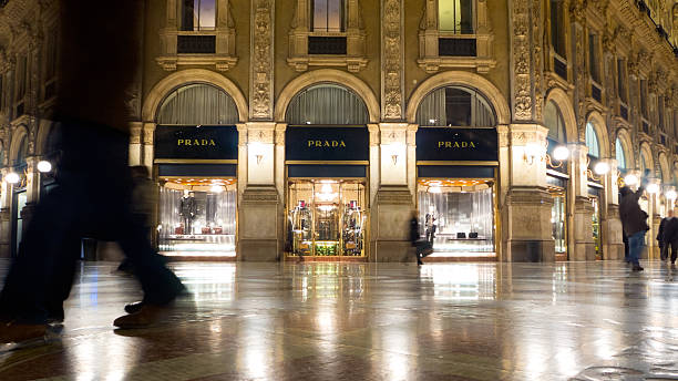 Prada Store Milan "Milan, Italy - January 29, 2013: The Prada store in the famous Gallery Vittorio Emanuele II, with blurred people on the foreground." galleria vittorio emanuele ii stock pictures, royalty-free photos & images