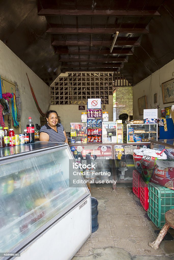 Convenience store, Granada, Nicaragua. "Granada, Nicaragua - September 14, 2012: A female small business owner standing in her convenience store in downtown Granada, Nicaragua.  With few large retailers in Nicaragua small stores offering the basics of food and toiletries are integral parts of the community.  Granada has grown considerably as a tourist destination and the local citizens have welcomed the influx of visitors with their characteristic openness and friendliness." Nicaragua Stock Photo