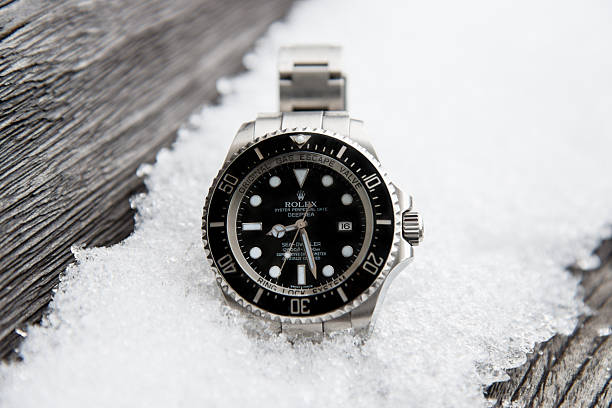 Rolex Seadweller DEEPSEA "Stuttgart, Germany - January 27, 2013: Rolex Oyster Perpetual DEEPSEA Seadweller Watch Reference 116660 outdoors on icy snow covered old wooden board." swiss culture photos stock pictures, royalty-free photos & images