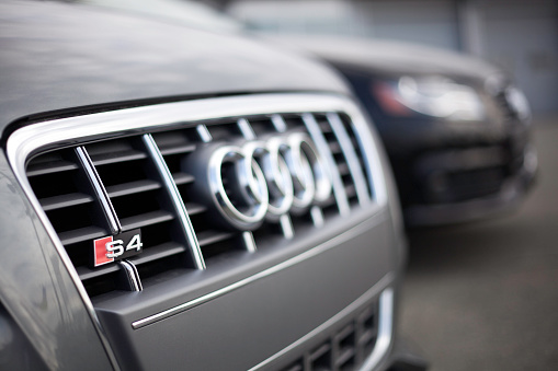 Halifax, Nova Scotia, Canada - March 18, 2012: At an Audi dealership in Halifax, Nova Scotia, the front fascia of two Audi vehicles including an Audi S4.  Very narrow focus with attention on the S4 emblem.  The Audi S4 is the high performance version of the popular Audi A4.  Beginning production in 1991, the S4 has gone through various versions and each time has increased in performance.