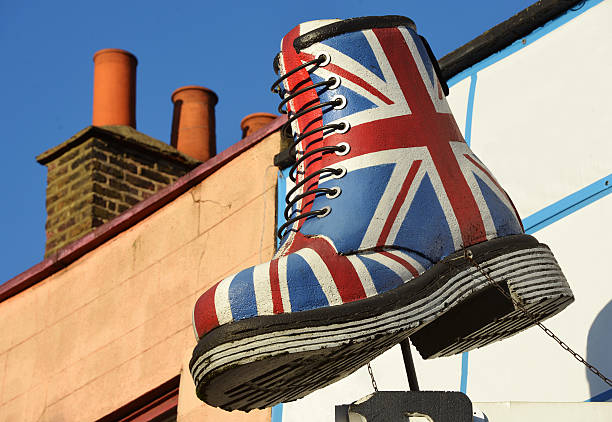 British Boot London, UK - January, 9th 2013:A large boot decorated with the British flag on display above street level in the Camden Market area of London camden lock stock pictures, royalty-free photos & images