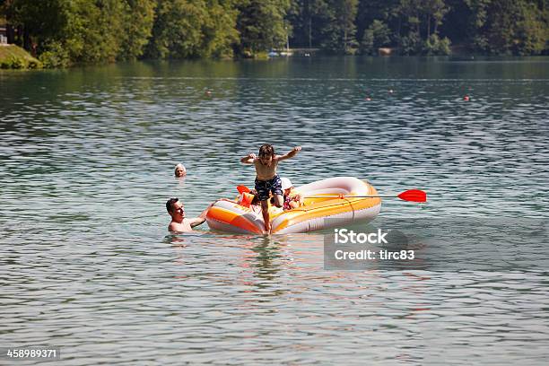 Boy Jumping Into The Lake Stock Photo - Download Image Now - Activity, Adult, Blurred Motion