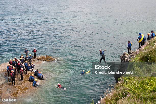 Group Of People Tombstoning In Newquay Stock Photo - Download Image Now - Activity, Adult, Adventure