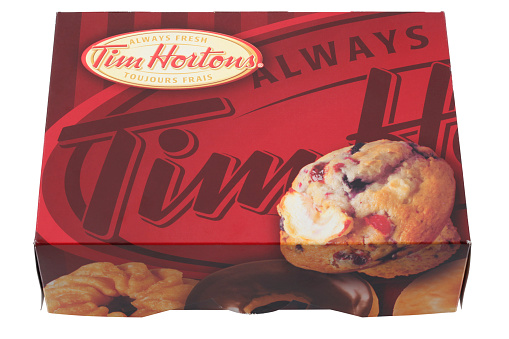 Cantley, Quebec, Canada - February 15, 2012: A box of Tim Hortons Donuts on a white background. Tim Hortons is a Canadian restaurant chain known for its Coffee and Donuts.