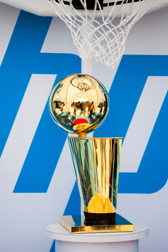 Halifax, Nova Scotia, Canada - September 8, 2012: The NBA Larry O'Brien Championship Trophy while on display at the outdoor NBA 3X at the Commons in Halifax, Nova Scotia.  HP logo visible behind trophy as a sponsor of the event.  People visible reflected in trophy.  The NBA 3X is a public event that tours across Canada.  Local players can register to play 3 x 3 basketball during the event.