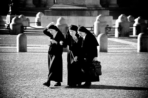 Vatican City, Vatica City State - August 22, 2008: Group of nuns walking towards the entrance of the St. Peter's Basilica during a pilgrimage to the Holy See, Vatican City State.