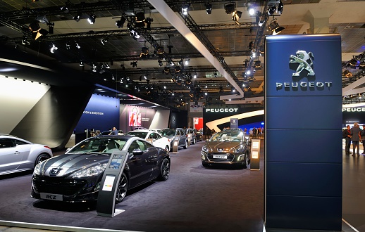 Brussels, Belgium - January 10, 2012: Peugeot RCZ on display during the 2012 Brussels motor show. People in the background are looking at the cars.