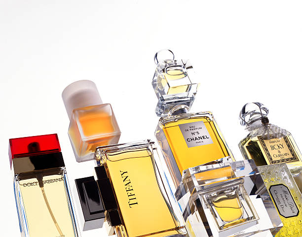 bottles of perfume "Leiden, The Netherlands - October 28, 2008: Product shot of bottles with perfume by Chanel, Guerlain, Christian Dior, Dolce & Gabbana and Tiffany & Co, shot in studio on white background." dior perfume stock pictures, royalty-free photos & images