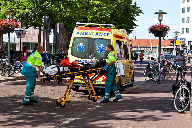 Ambulance "Deventer, the Netherlands - July, 7, 2012: Ambulance employees run with an empty stretcher to place accident." deventer photos stock pictures, royalty-free photos & images