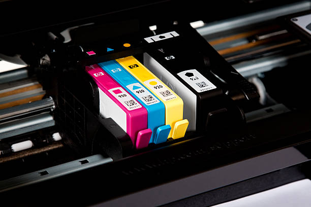 Hewlett Packard Ink Cartridges "Chula Vista, USA - March 15, 2012: Hewlett Packard Ink Cartridges for a HP Officejet printer.  Color and black ink cartridges are in the printer." cartridge stock pictures, royalty-free photos & images