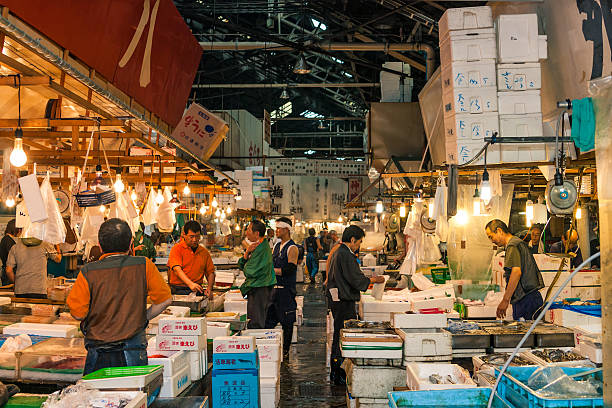 Tokyo, Japan - June 22, 2009: Tsukiji Market - Retailers selling fish at Tsukiji fish market, Japan's largest fish market