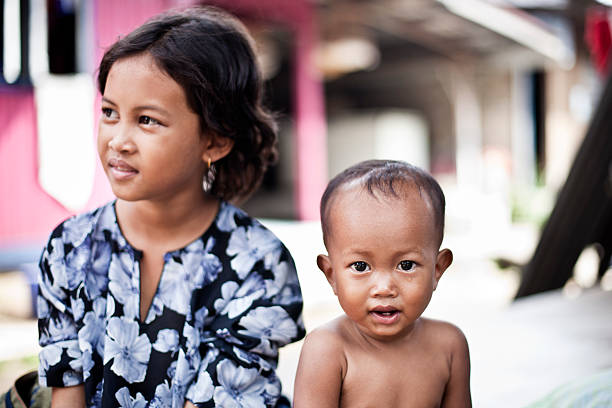 Happy Cambodian children in village near Siem Reap, Cambodia. Sampeah is a Cambodian greeting and it's similar to Indian namaste.