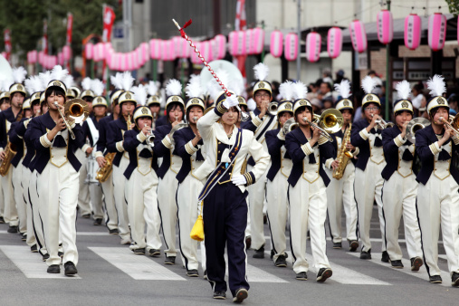 Kagoshima, Japan - November 3, 2011: Brass band marching through the street at Ohara Matsuri Festival. Ohara Matsuri Festival is Kagoshima's biggest festival is held on the 2nd and 3rd of November. The 2-day festival is arranged around traditional dances performed by thousands of citizens and guests.
