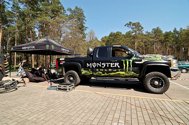 Monster Energy truck "Druskininkai, Lithuania - April 28, 2012: Monster Energy truck Chevrolet Silverado Z71 all covered with Monster Energy stickers parked at parking lot near Monster Energy tent at first in Lithuania Longboard Day event at resort Druskininkai in Lithuania." monster energy stock pictures, royalty-free photos & images