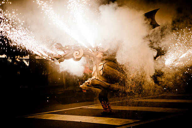 Sant Sadurni d Anoia, Spain - September 10, 2011: A dragon spitting fire during a Correfoc festival at night in Sant Sadurni d Anoia. Correfocs are traditional festivals in Catalonia in Spain. People dressed in devil costumes dance in the streets of theit towns and cities among fireworks.They often also use demons and dragon figures that spit smoke and fire.