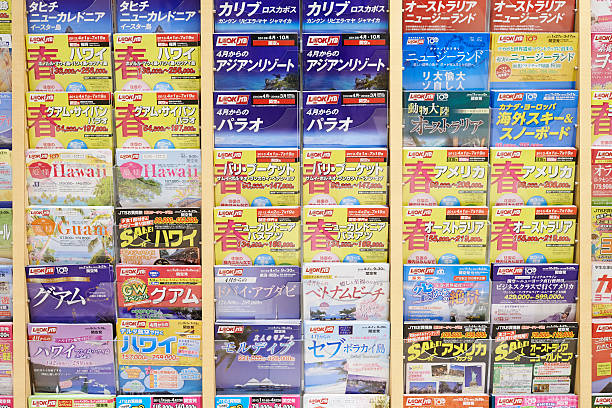 Japanese Tour Catalogs "Osaka, Japan - March 02, 2013: rack with brochures offering packaged tours at a Look JTB branch located in Osaka Station City." akaishi mountains stock pictures, royalty-free photos & images