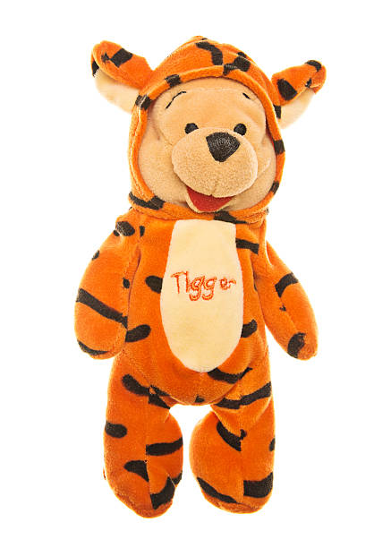Winnie-the-Pooh Teddy Bear in Tigger Costume "Albuquerque, USA - May 3, 2012: Winnie-the-Pooh is a popular character from Winnie-the-Pooh childrens books. The stories, popular worldwide, were written by A. A. Milne and they feature adventures of a teddy bear called Winnie-the-Pooh and his friends Piglet, Eeyore, Owl, Tigger and,  Rabbit." winnie the pooh photos stock pictures, royalty-free photos & images