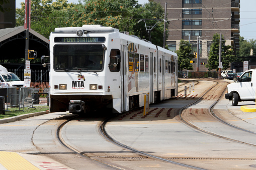 Baltimore, MD, USA - July 14, 2011: A Baltimore Light Rail arrives at the Mount Royal station in downtown Baltimore to discharge passengers. The Baltimore Light Rail System is a 30 mile transit system opened in 1992. The Light Rail serves passengers in downtown Baltimore as well as surrounding areas of Maryland including Timonium, Hunt Valley, Glen Burnie, Baltimore Washington International Airport and others.