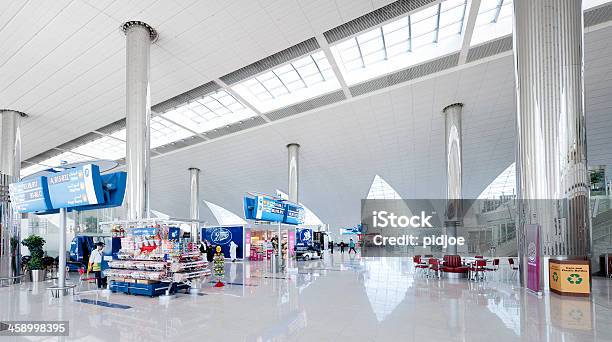 People Walking In Contemporary Airport Lounge Stock Photo - Download Image Now - Airport, Airport Departure Area, Architectural Column
