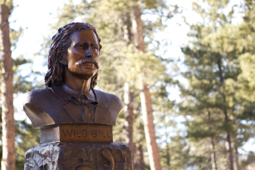Deadwood, South Dakota, United States - March 9, 2012. Wild Bill Hickok's grave in Mt. Moriah Cemetery. A prominent figure in the american wild west, he was shot in the head by Jack McCall while gambling at the No.10 Saloon.