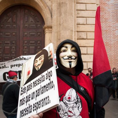 Valencia, Spain, February 19, 2012. Demonstration against social and economic policies of the Spanish government. An Anonymous member with a banner that says \