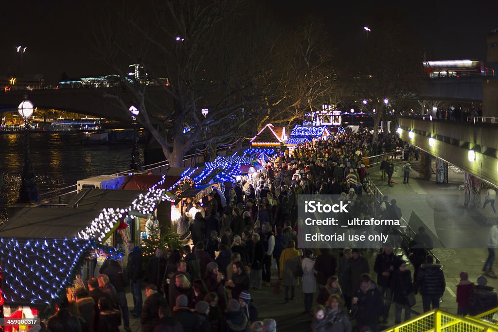 Southbank Christmas Market "London, UK - December 01, 2012: People walking and shopping after sunset at the authentically decorated and illuminated wooden chalets of the Christmas Market promenade at the Southbank Centre London." Building Exterior Stock Photo