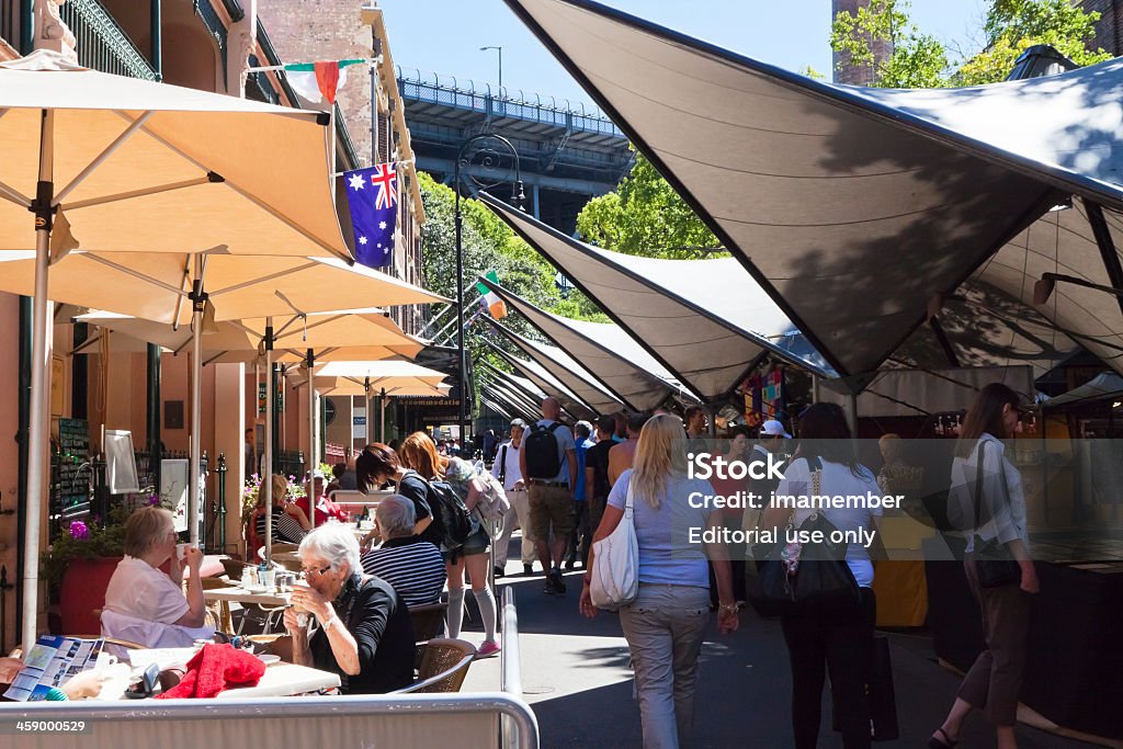 The Rocks market Sydney, Australia - March 24, 2012: The Rocks is best known and most creative market in Sydney. Big crowd enjoying sunny day at the Rocks market with plenty of stalls with big variety of things to buy and restaurants for coffee brake. The Rocks - Sydney Stock Photo