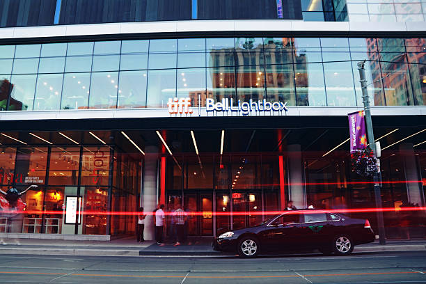 Tiff Bell Lightbox Festival Tower "Toronto, Canada - July 20, 2012: Tiff Bell Lightbox Festival Tower in the Entertainment District with people and traffic in blurred motions." toronto international film festival stock pictures, royalty-free photos & images