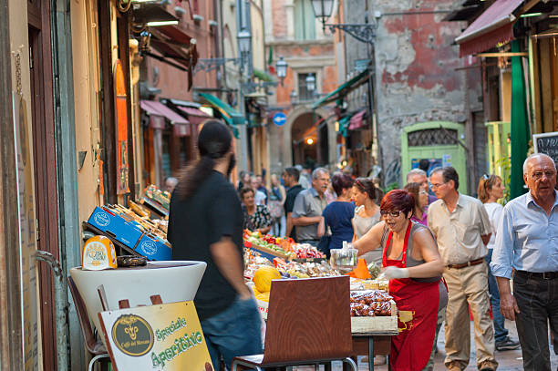 Bologna, Italy - October 3, 2011: People shopping in the old part of Bologna for local food.
