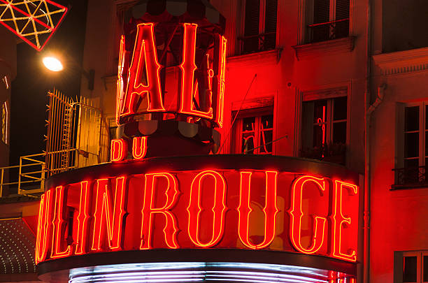 Le Moulin Rouge cabaret in the night on Paris "Paris, France - February 8, 2012: Le Moulin Rouge cabaret in the night on Paris. The moulin rouge is a cabaret built at the end of 1800 situated in Montmartre district of Paris. In this zone there are some red light night bar and sexy shop." place pigalle stock pictures, royalty-free photos & images