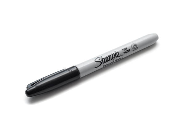 Sharpie "Vancouver, Canada -- March 14, 2012:Close up of a Sharpie brand black marker on a white background with shadows." permanent marker photos stock pictures, royalty-free photos & images