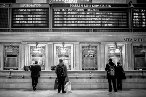 New York , USA - March 16, 2012 : Black and white image of commuters in Grand Central station queueing for the ticket train.