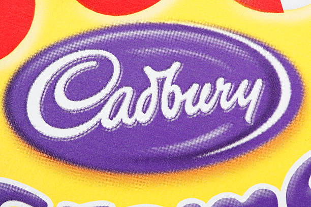 Cadbury logo Cantley, Canada - February 15, 2012: A Cadbury logo on a box of Cadbury Cream Egg Snack Cakes. Cadbury is a company owned by Kraft Foods cadbury plc photos stock pictures, royalty-free photos & images