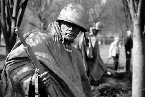 Washington DC, USA - April 9, 2008: An elderly couple (background) walks past sculptures of soldiers at the Korean War Memorial, located adjacent to the Lincoln Memorial in Washington DC