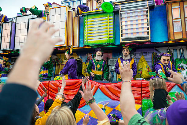 New Orleans, LA. USA - March 8, 2011. A member of the Krewe or Rex tosses beads to spectator at Mardi Gras Parade.