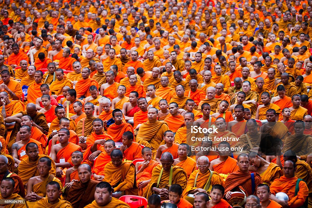 Mass Alms Giving in Bangkok Bangkok, Thailand - March 18, 2012: Monks are participating in a Mass Alms Giving of 12,600 monks in Central World for the Makha Bucha celebrations in Bangkok, Thailand Monk - Religious Occupation Stock Photo