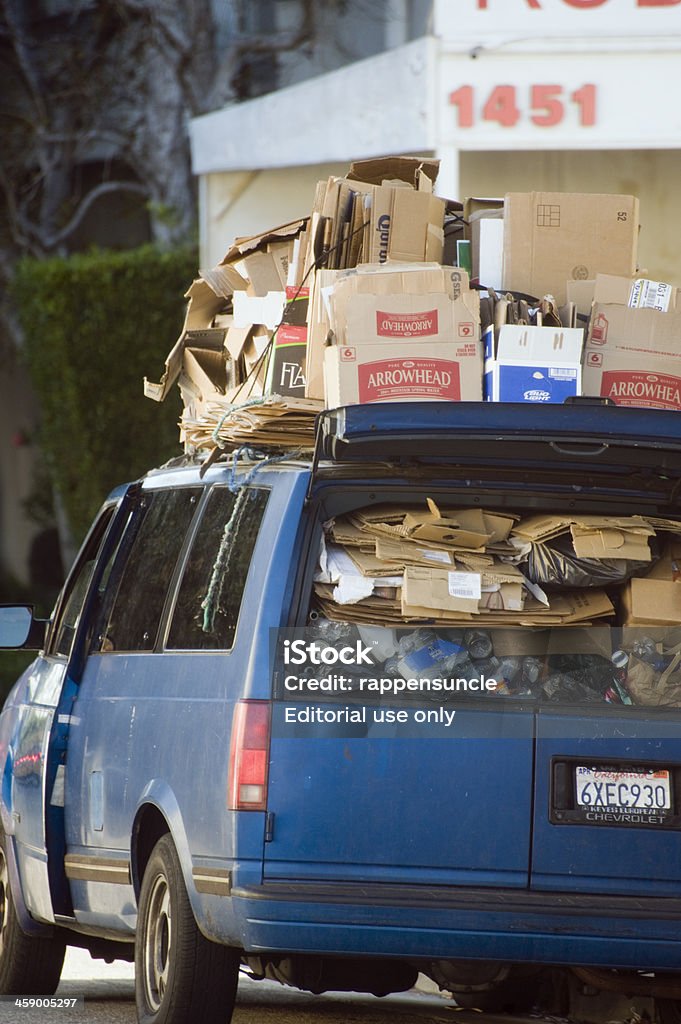 van full of cardboard "Los Angeles, California, USA - February 20, 2013: An old model Chevy van is stuffed to the gills full of flattened cardboard and in route to the recycling yard." Full Stock Photo