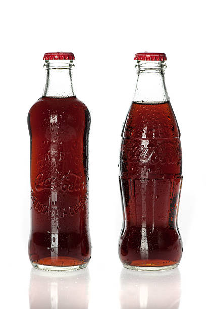 Valencia, Spain - May 15, 2016: close-up shot of empty vintage coca-cola bottles in red plastic case left in the street, in sunset light.