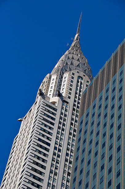 Chrysler Building, Art Deco Architecture, Midtown Manhattan, New York City "New York City, USA - March 14, 2012: A view of the iconic Chrysler Building's upper floors, crown and stainless steel eagles that decorate the Art Deco Style skyscraper along E.42nd Street in Midtown Manhattan." chrysler building eagles stock pictures, royalty-free photos & images